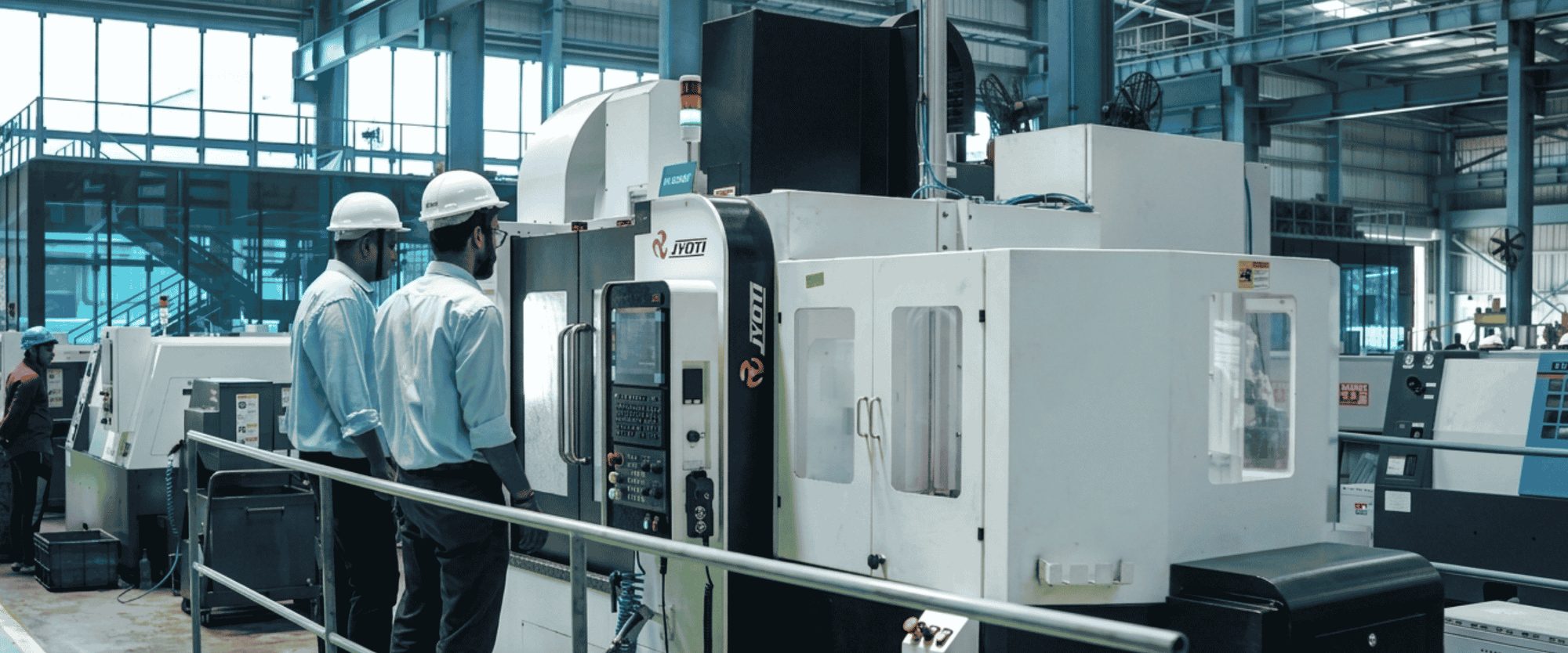 Engineers at a CNC machining centre